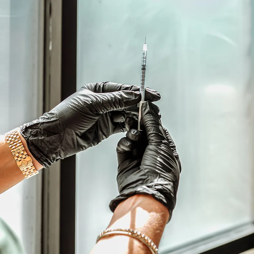 Gloved hands preparing a syringe at Contour & Sculpt Aesthetics